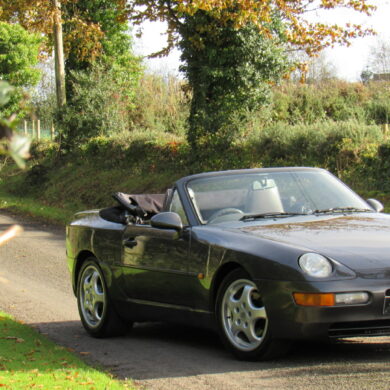 Three-quarter side view of a gray Porsche 968 convertible