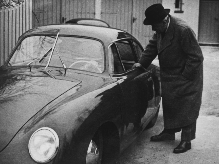 1950. Ferdinand Porsche standing next to the aluminium-bodied 356 built in Gmünd. Son Ferry Porsche at the wheel. Behind the car is the double garage of Porsche's villa in Stuttgart, in which the first Volkswagen prototypes were built.