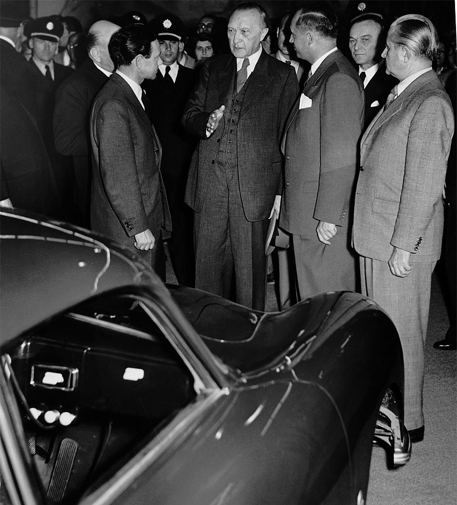1951 IAA Frankfurt. Ferry Porsche in conversation with Chancellor Konrad Adenauer and Prof. Dr. Heinrich Nordhoff, general manager of the VW. © Porsche
