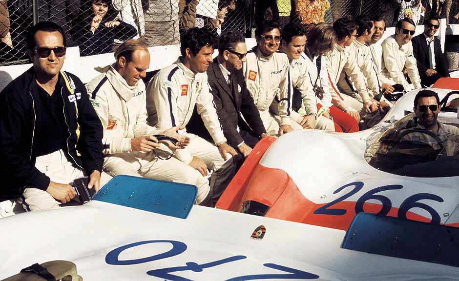 1969 May 4, Targa Florio. Umberto Maglioli, Dick Attwood, Brian Redman, Ferry Porsche, Hans Herrmann, Udo Schütz, Rolf Stommelen (with glasses), Vic Elford, Rudi Lins and Gérard Larrousse. Gerhard Mitter is at the wheel of the Porsche 908/02K Spyder. The 1969 Targa Florio marked one of Porsche's greatest successes in motor racing. 1st place went to Mitter/Schütz; 2nd to Elford/Maglioli; 3rd to Herrmann/Stommelen; and 4th to Karl von Wendt and Willi Kauhsen. All were in Porsche 908/02K Spyders.