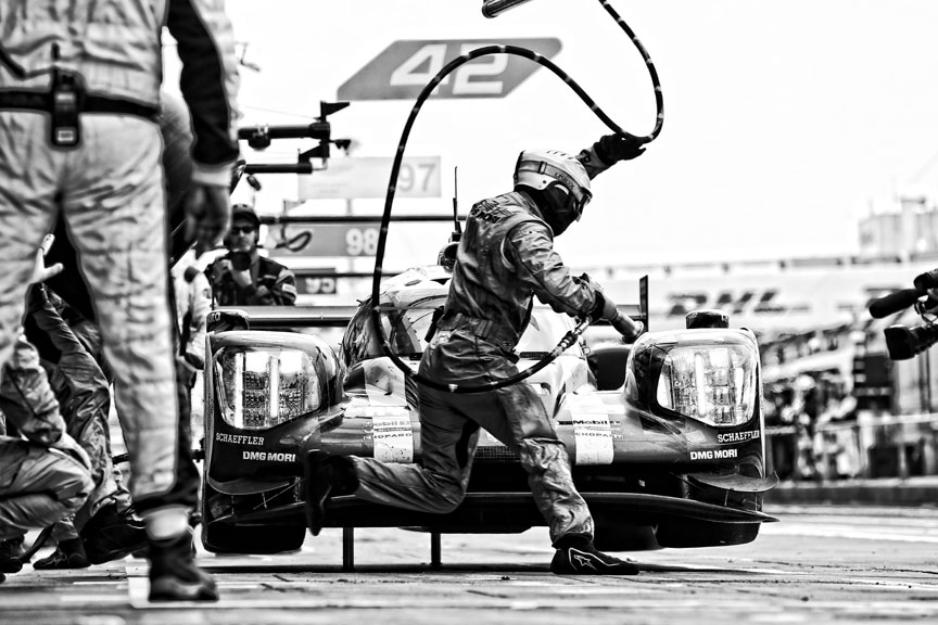 It looks cooler in black-and-white because back in the days of B&W-photography motorsport was a cool thing