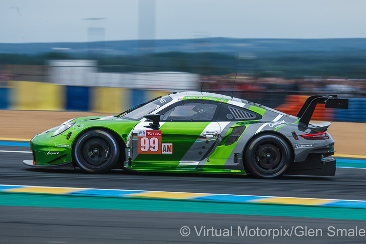 The #99 Proton Competition Porsche 911 RSR (GTE Am) driven by Patrick Long, Timothy Pappas and Spencer Pumpelly approaches the Dunlop Bridge