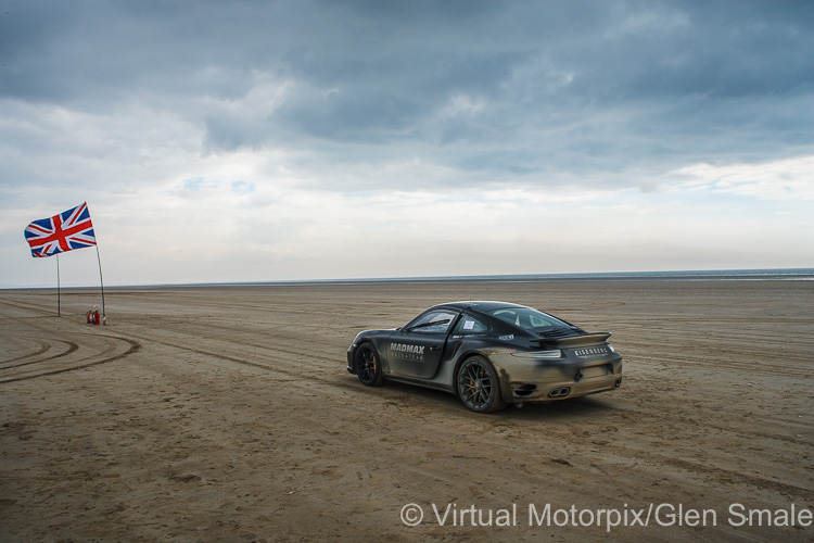 The 2015 Porsche 911 Turbo S presents a lonely figure on a flat, wind-swept beach The 2015 Porsche 911 Turbo S presents a lonely figure on a flat, wind-swept beach