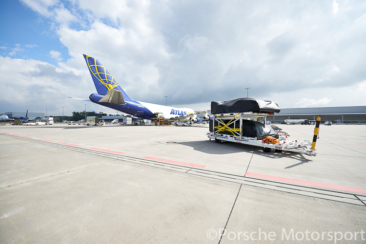 The two Porsche 919 Hybrid race cars are prepared for loading aboard the air freighter