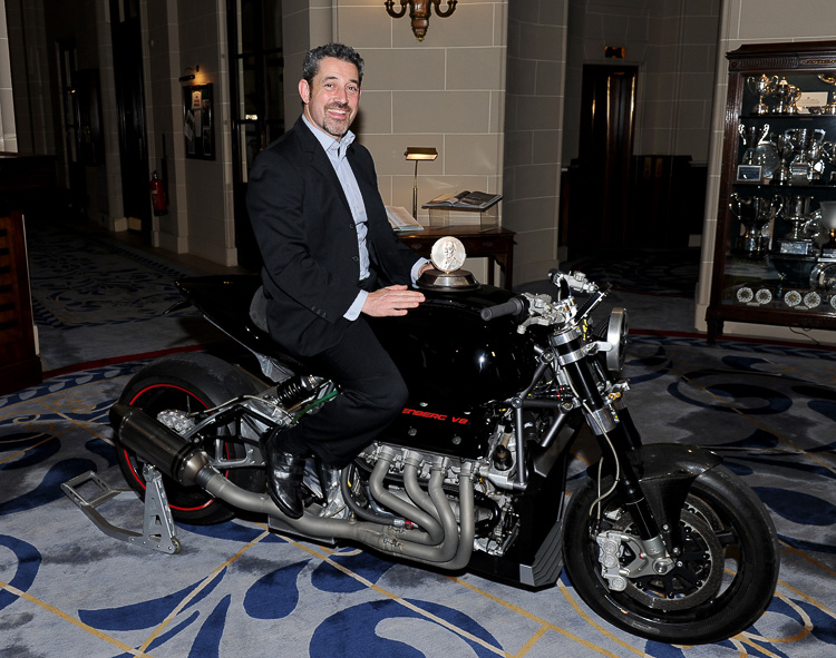 Zef Eisenberg sits on his record breaking motorcycle with the Simms Medal