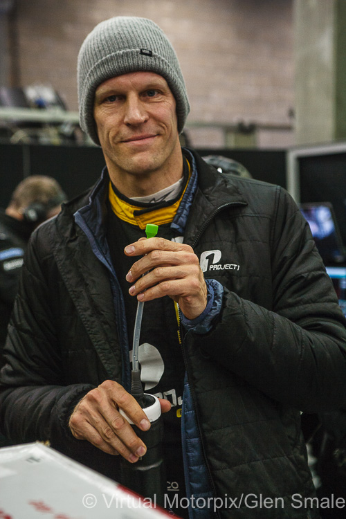 Jörg Bergmeister takes a break in the team’s pit garage Jörg Bergmeister takes a break in the team’s pit garage