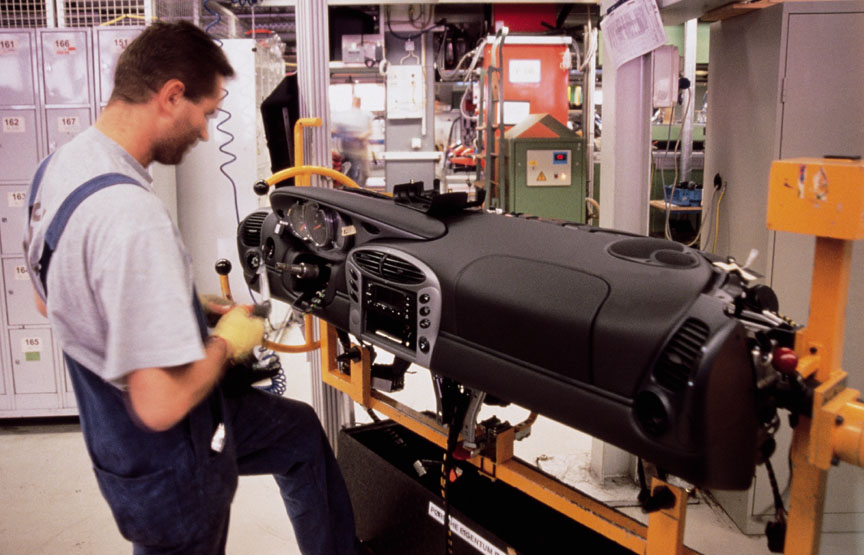 Porsche Boxster 986 dashboard being mounted