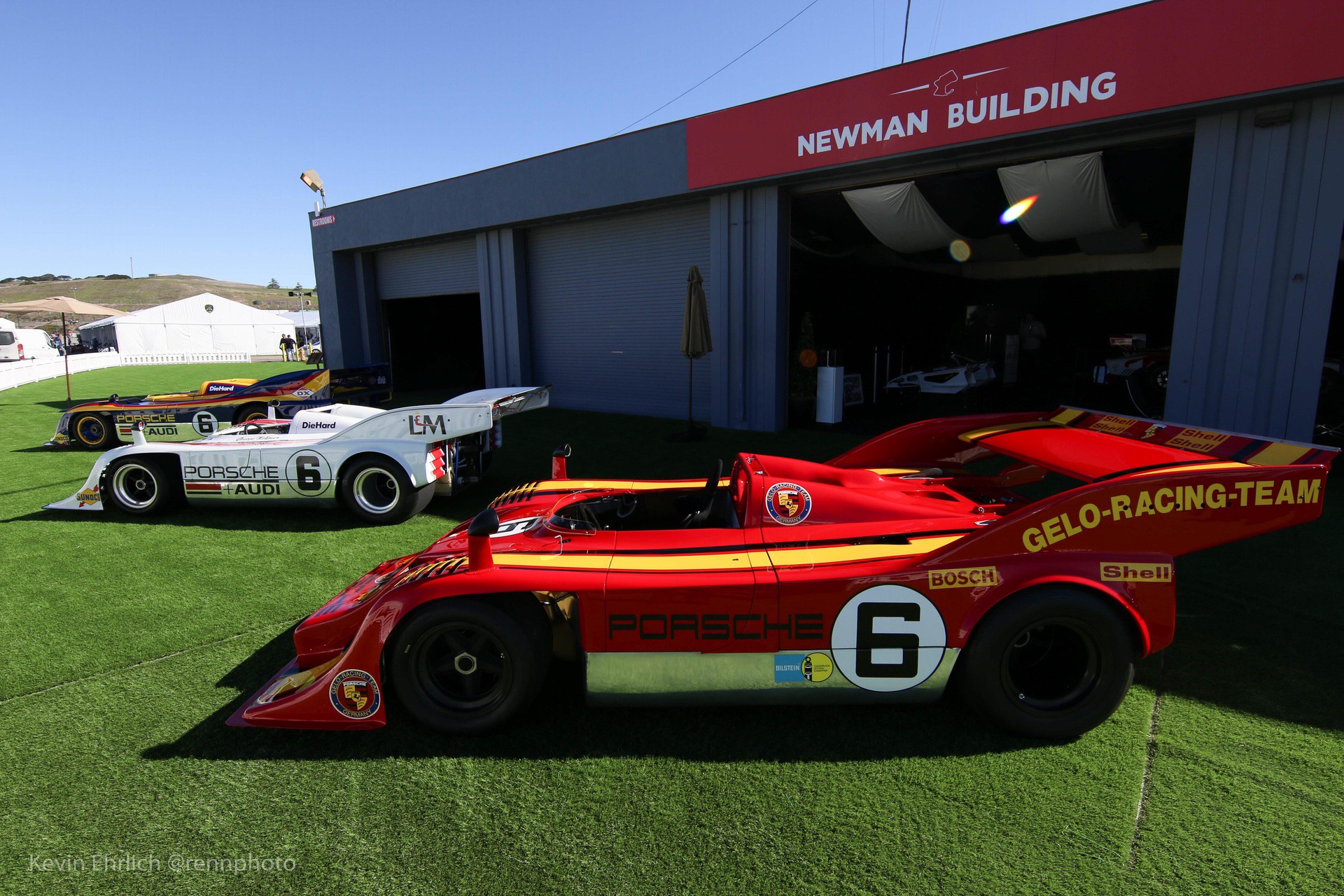 3 Porsche 917s on grass outside building at Velocity Invitational