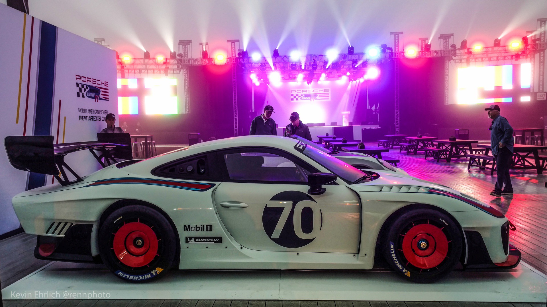 Side view of Porsche 935/19 at event with neon lights in background