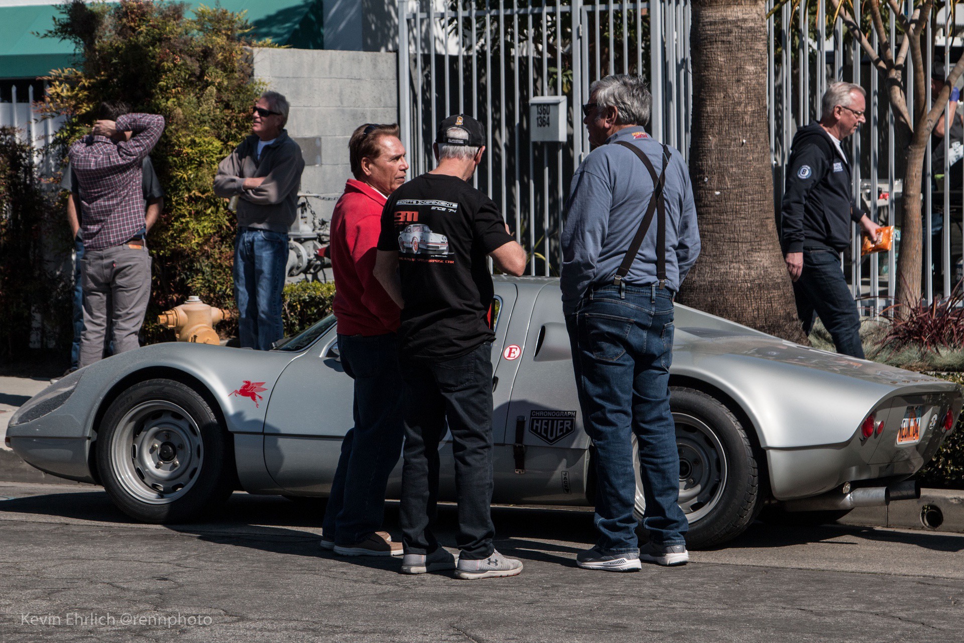Group of men standing near vintage Porsche during 2022 Lit Show in LA