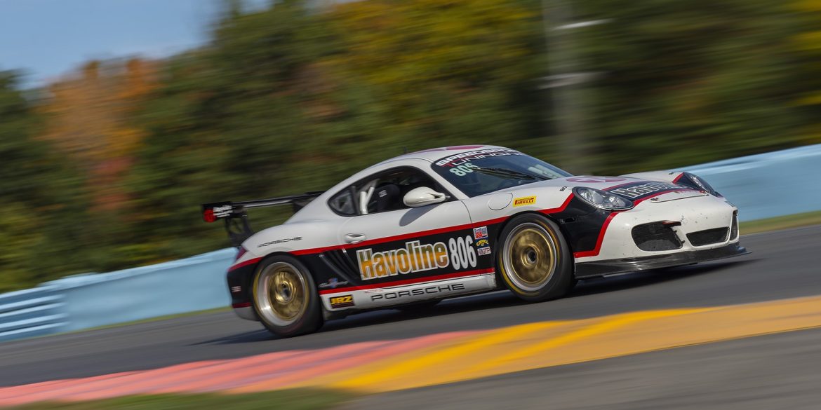 Porsche Cayman driving on track at speed