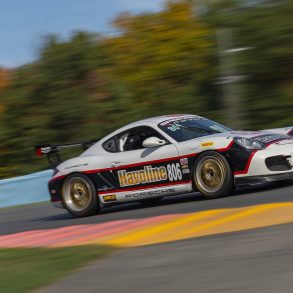 Porsche Cayman driving on track at speed