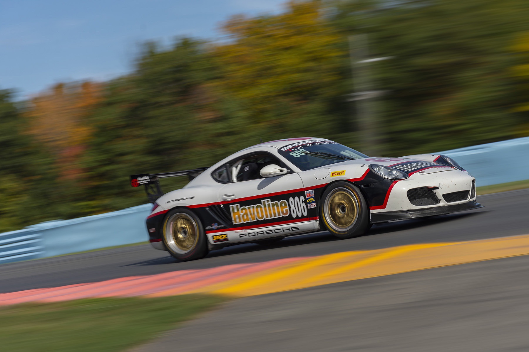 Porsche Cayman driving on track at speed