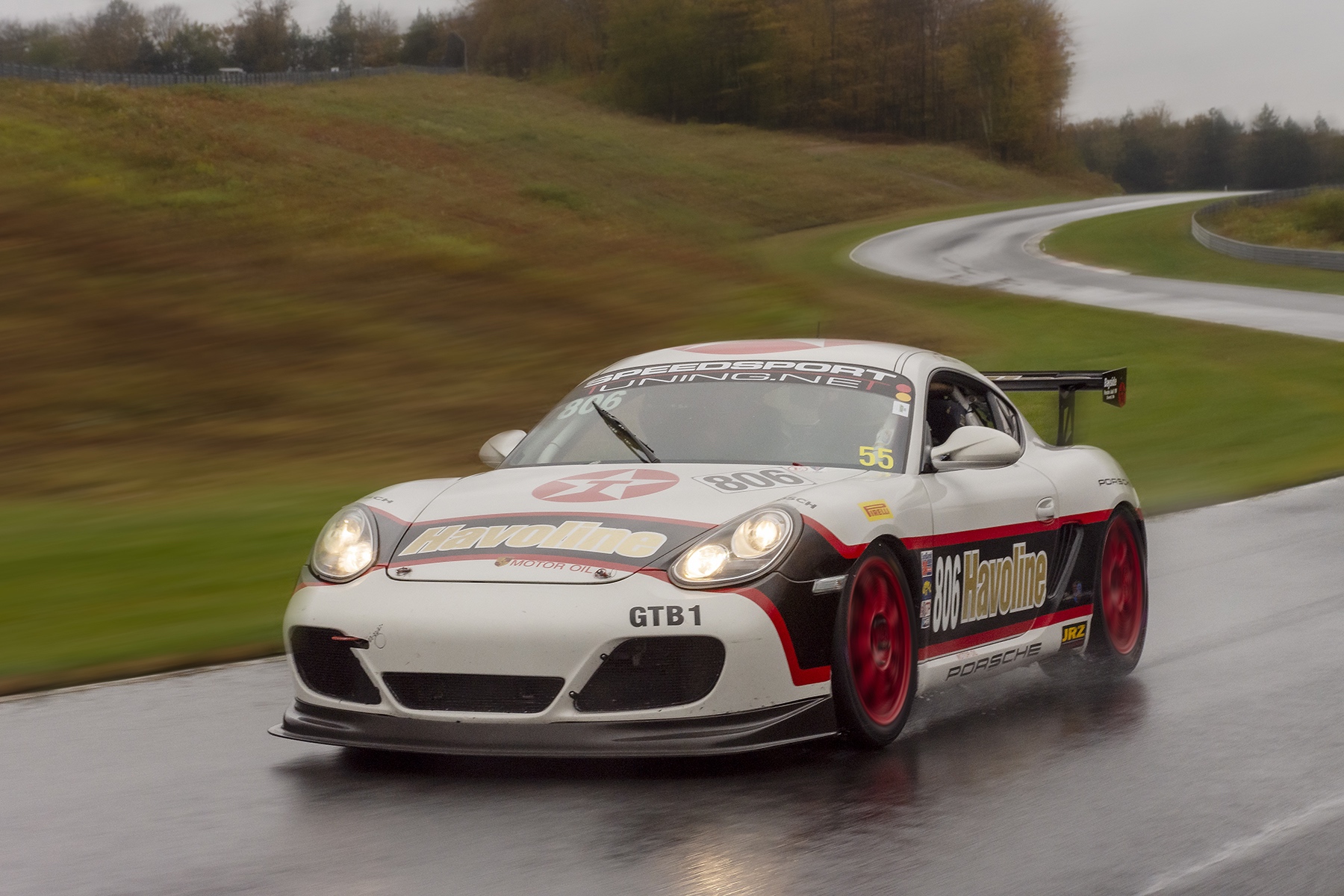 Porsche Cayman driving on track at Monticello Motor Club