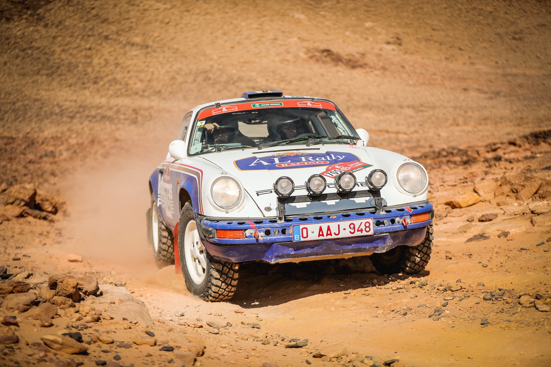 Front of Porsche 911 SC being driven in desert during 2022 Dakar Classic