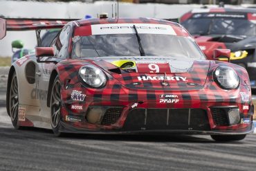 Porsche in red and black plaid livery on track at Sebring 2022