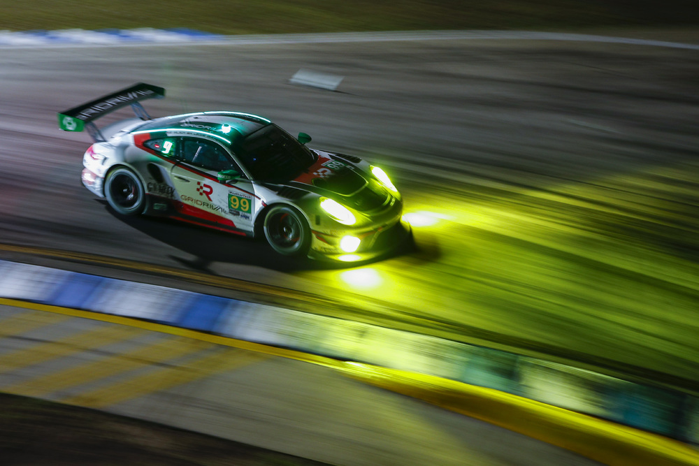 #99 Porsche on track at night during Sebring 2022