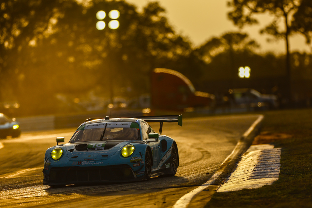 #16 Wright Motorsports Porsche on track at sunset during Sebring 2022