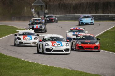 Various Porsche racecars on the track