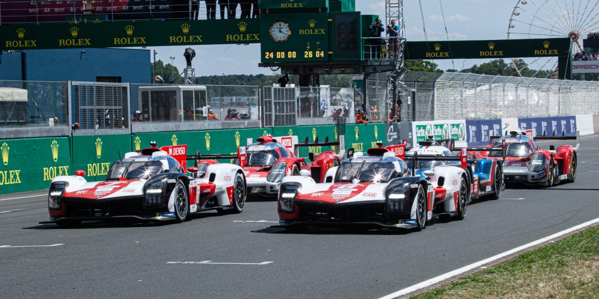 The No. 8 Toyota (closest to the camera) leads the Hypercar class across the start line