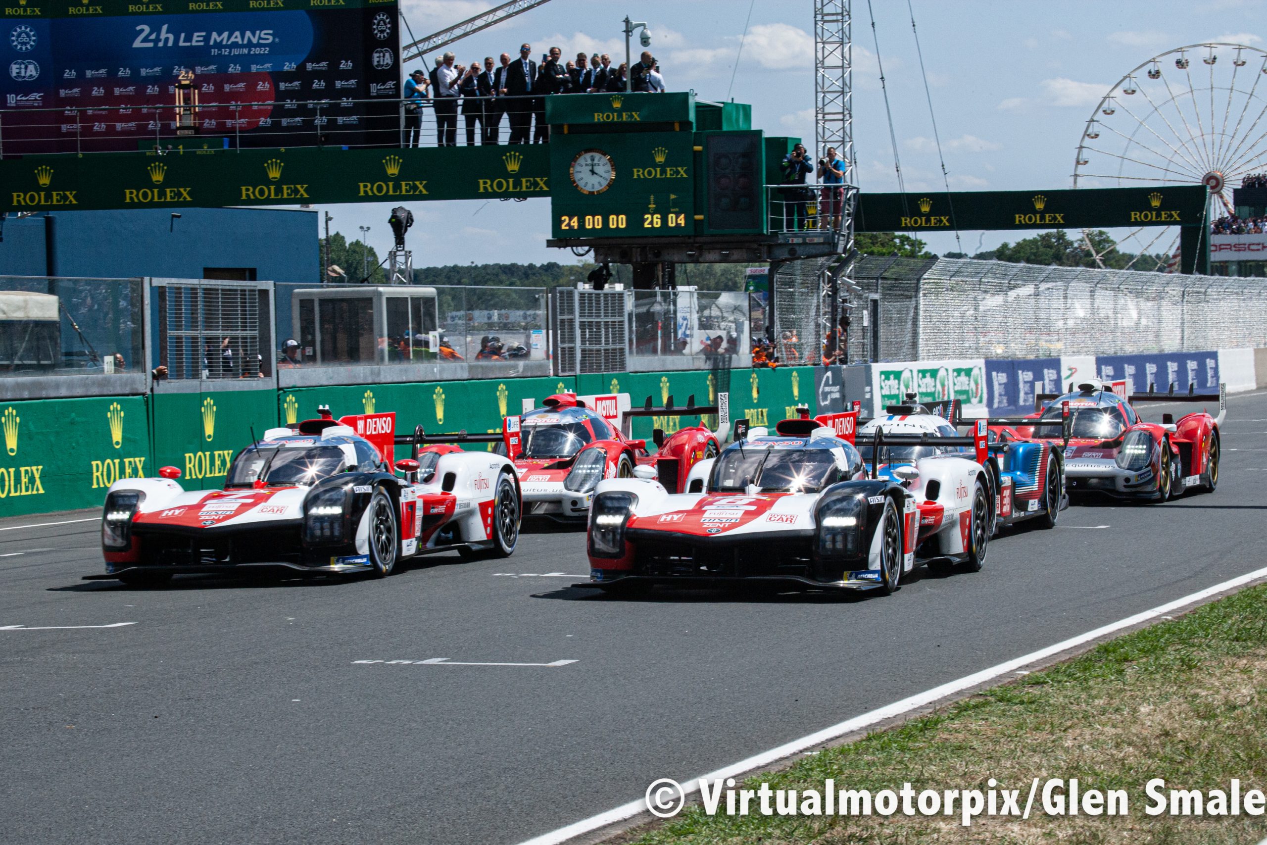 The No. 8 Toyota (closest to the camera) leads the Hypercar class across the start line