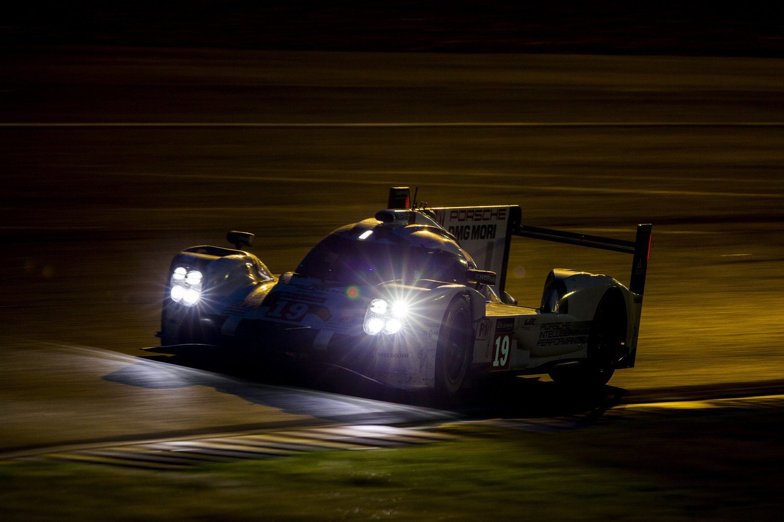 LED headlamps on high speed race cars during Le Mans at night
