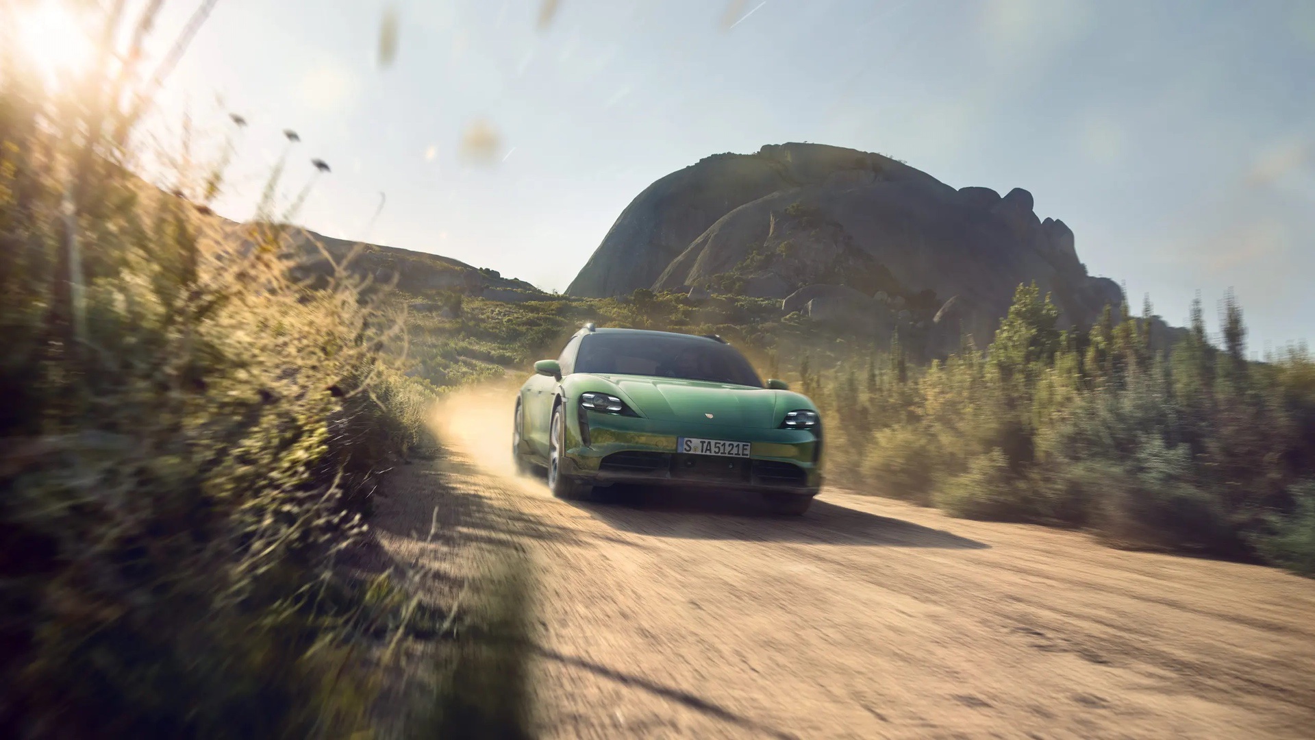 Porsche Taycan driving through desert