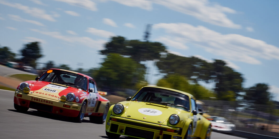 Porsches joust for position on the run down to Tertre Rouge, in the Porsche Classic Race.