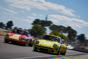 Porsches joust for position on the run down to Tertre Rouge, in the Porsche Classic Race.