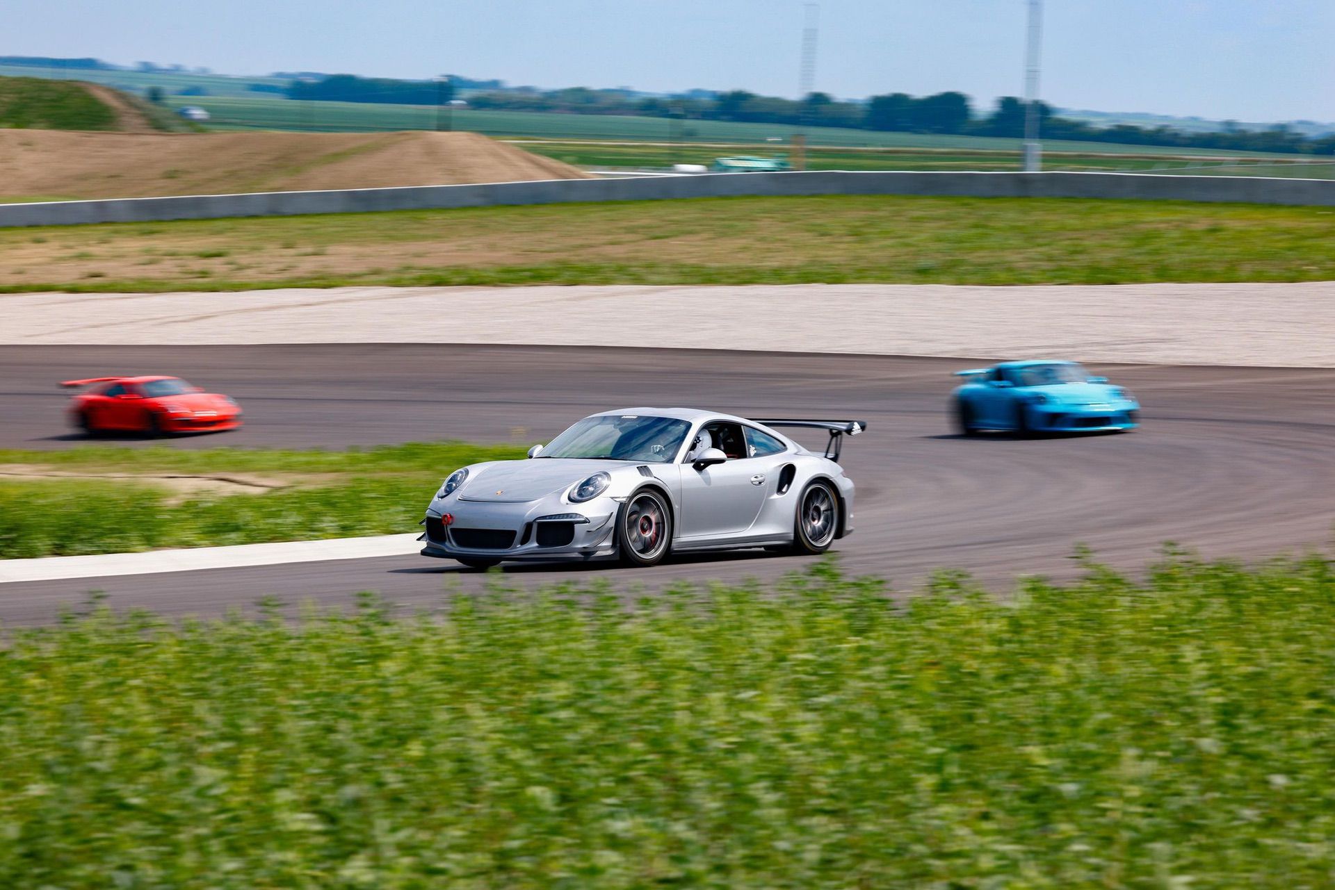 Porsche ahead of other cars on track during high performance driving event