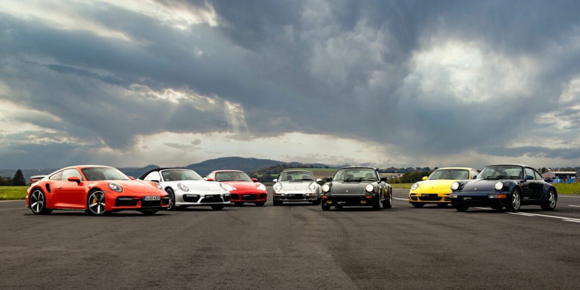 Porsche 911 cars in different colors parked outside on road