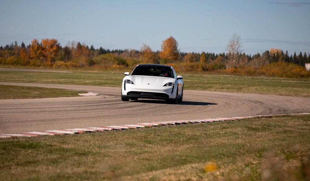 Porsche EV driving around curve on racetrack