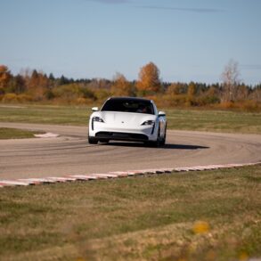 Porsche EV driving around curve on racetrack