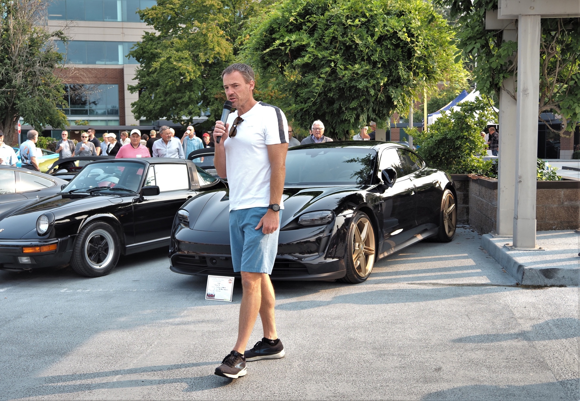 Black Porsche cars parked in lot during presentation at event