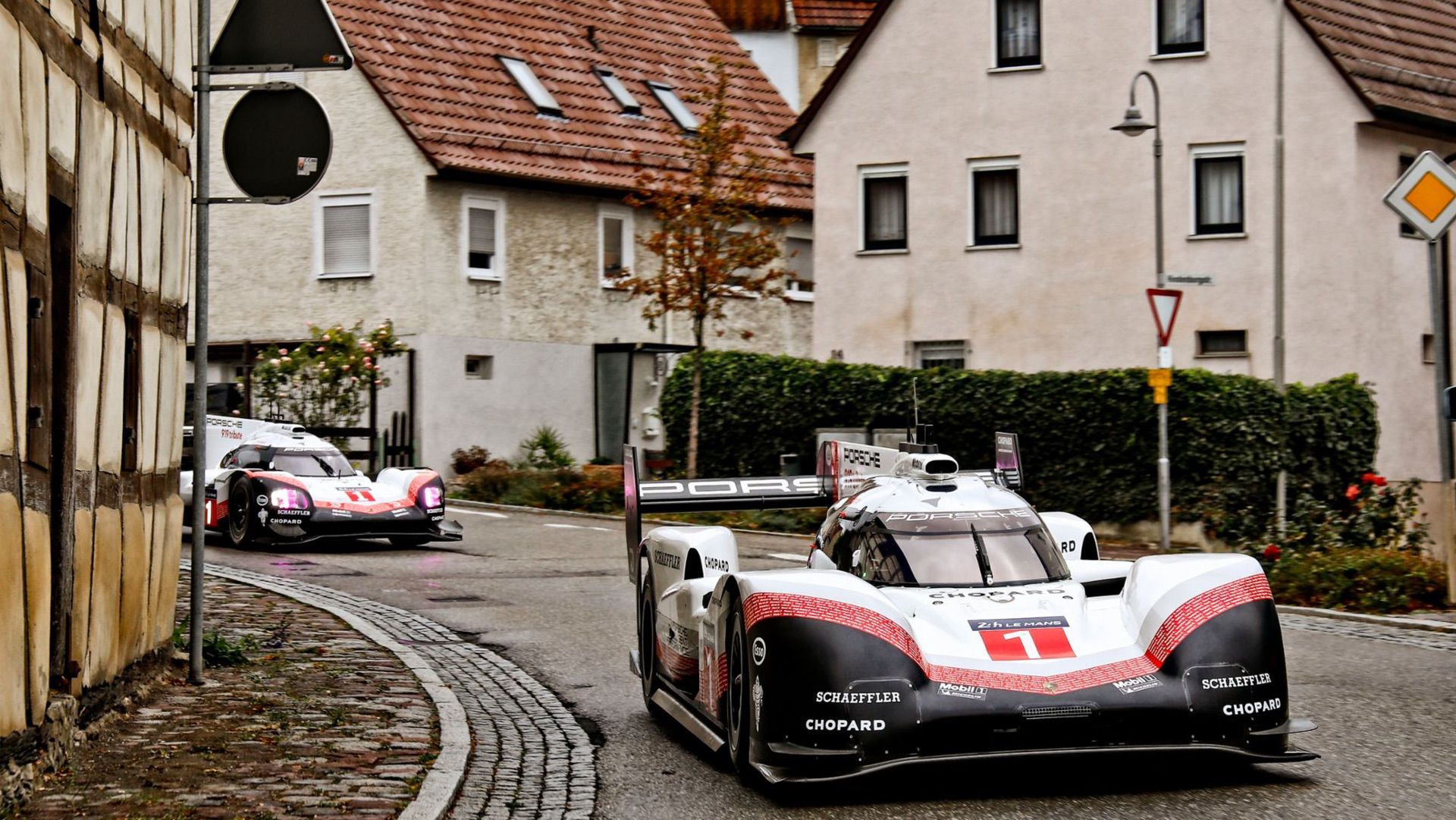 Porsche promotional image of the 919 LMP1h race car in a sleepy village