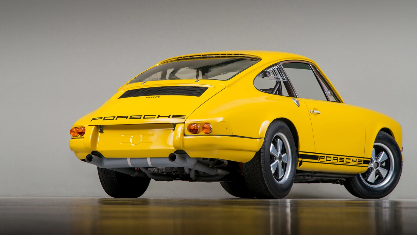 Rear-angled view of a yellow 1967 Porsche 911R.
