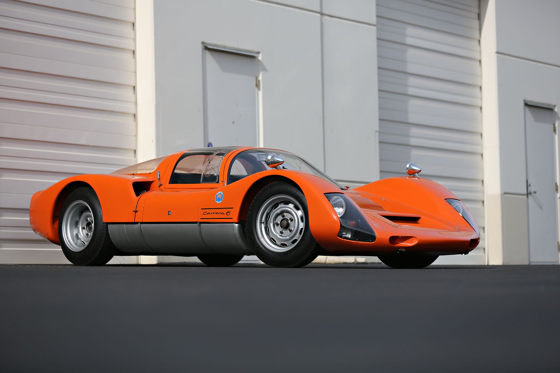 front-angled view of an orange Porsche 906