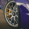 Front wheels on a purple Porsche