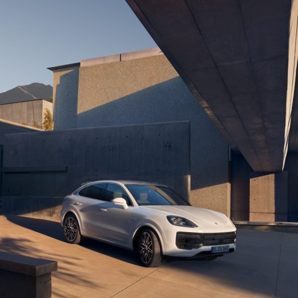 Three-quarter side view of a 2024 white Porsche Cayenne Turbo E-Hybrid Coupe