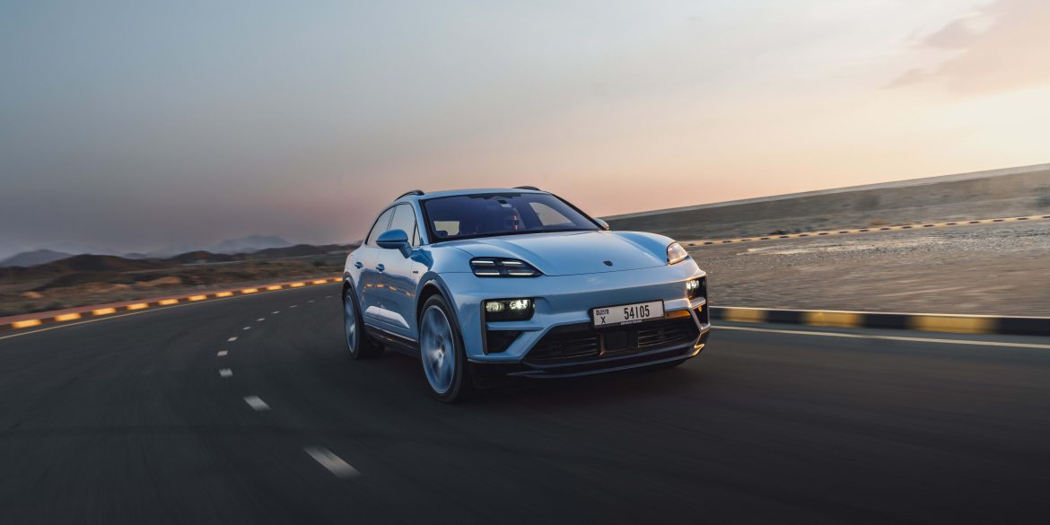 Three-quarter side view of a 2024 blue Porsche Macan Turbo Electric