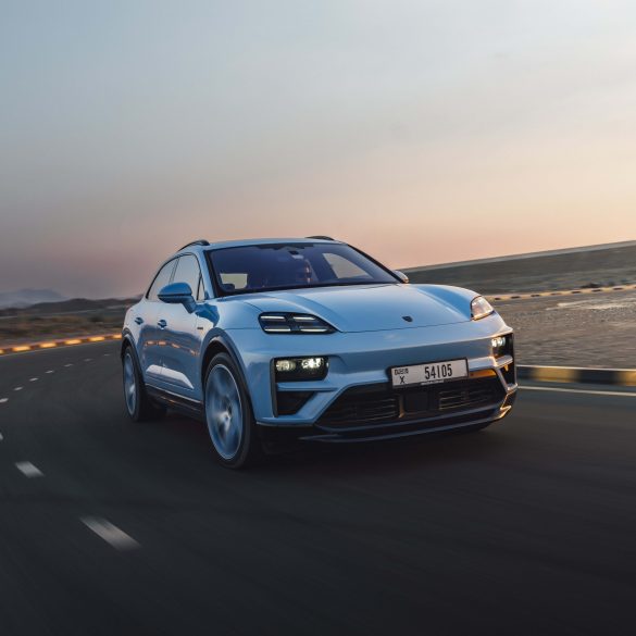 Three-quarter side view of a 2024 blue Porsche Macan Turbo Electric