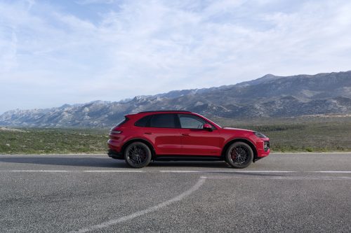 Side view of a 2024 red Porsche Cayenne GTS