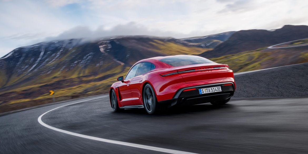Three-quarter rear view of a 2025 red Porsche Taycan GTS