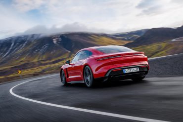 Three-quarter rear view of a 2025 red Porsche Taycan GTS