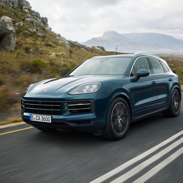 Three-quarter side view of a 2024 blue Porsche Cayenne