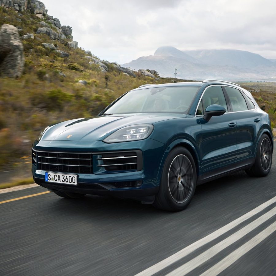 Three-quarter side view of a 2024 blue Porsche Cayenne