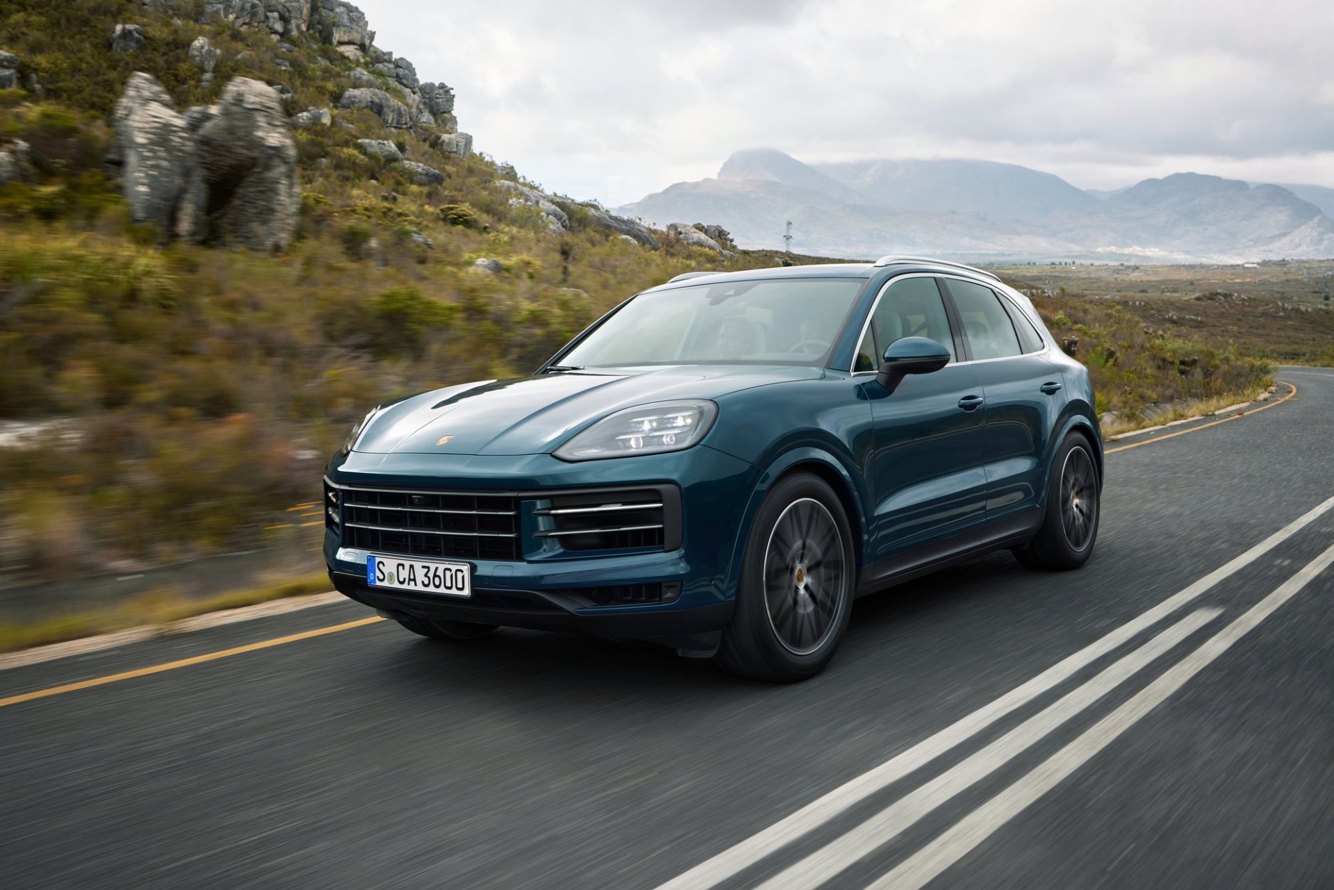 Three-quarter side view of a 2024 blue Porsche Cayenne