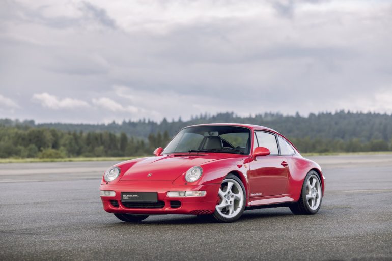 Three-quarter view of a red Porsche 911 Type 993 Carrera 4S