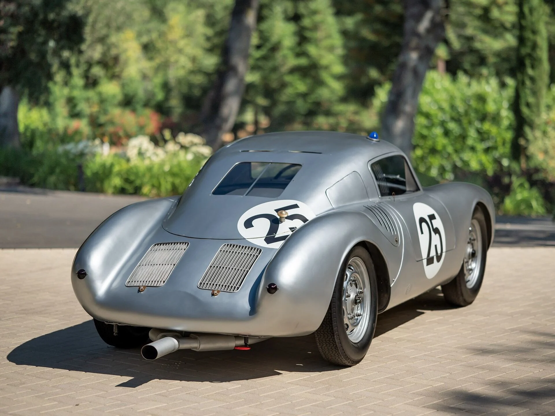 With its tubular spaceframe chassis increasing torsional rigidity and the four-cam Type 547 pushing into the mid-130 horsepower range, the 550A translated engineering refinement directly into results. In 1956, it delivered one of Porsche’s defining early victories with Umberto Maglioli’s overall win at the Targa Florio, defeating significantly larger-engined rivals on outright pace and endurance. It continued to secure class victories at Le Mans and across European hill climbs and road races, reinforcing Porsche’s efficiency-over-displacement doctrine. By the time the 550A’s career matured, it had moved Porsche from promising upstart to disciplined international contender.