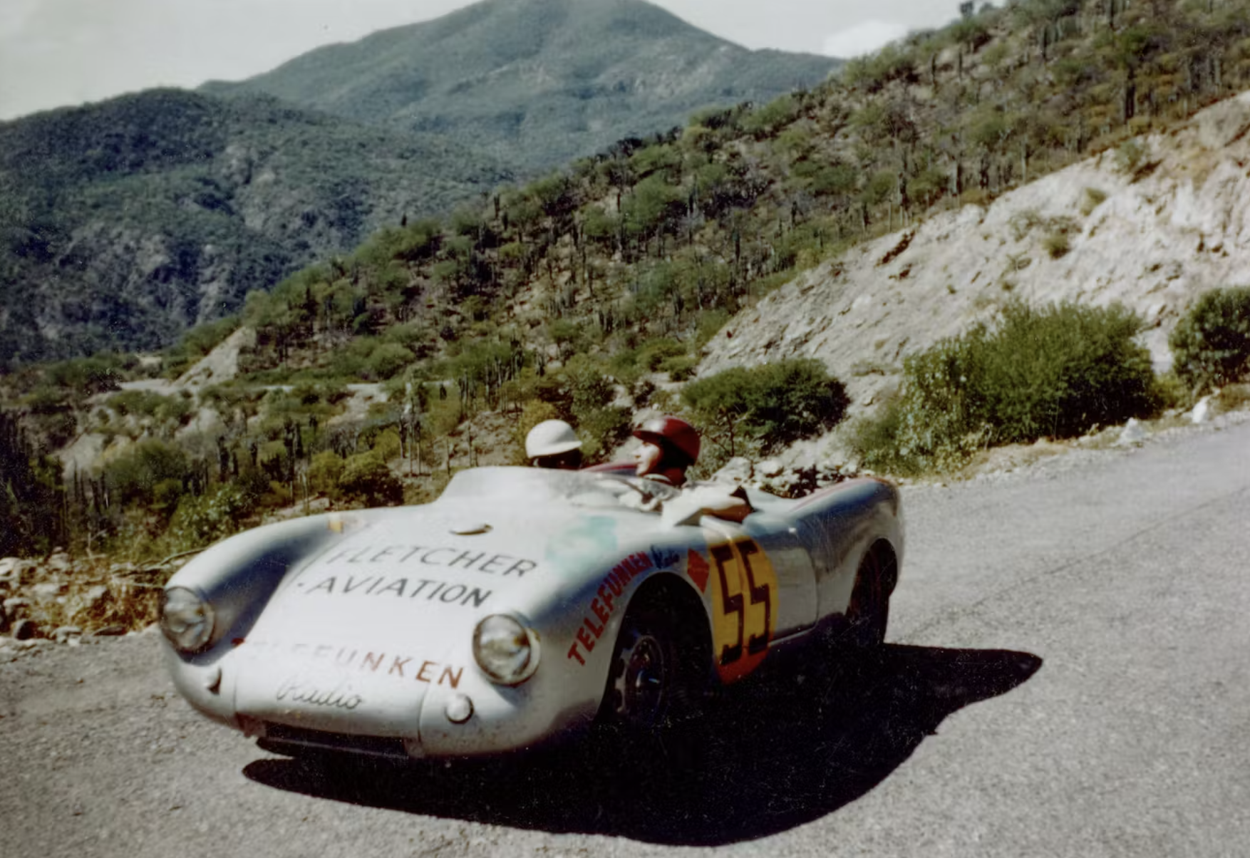 Hans Herrmann (right) and mechanic Herbert Linge take a break at the 1954 Carrera Panamericana, their Porsche 550 paused against the vast Mexican landscape. The image captures the paradox of the event: moments of stillness set within a race defined by relentless mechanical and environmental strain. At altitude, across mountain passes and sun-baked straights, the 550’s balance and efficiency were not theoretical virtues — they were survival tools. Herrmann’s eventual class victory was earned not only through speed, but through discipline, restraint, and mechanical sympathy across one of the harshest road races of the era.